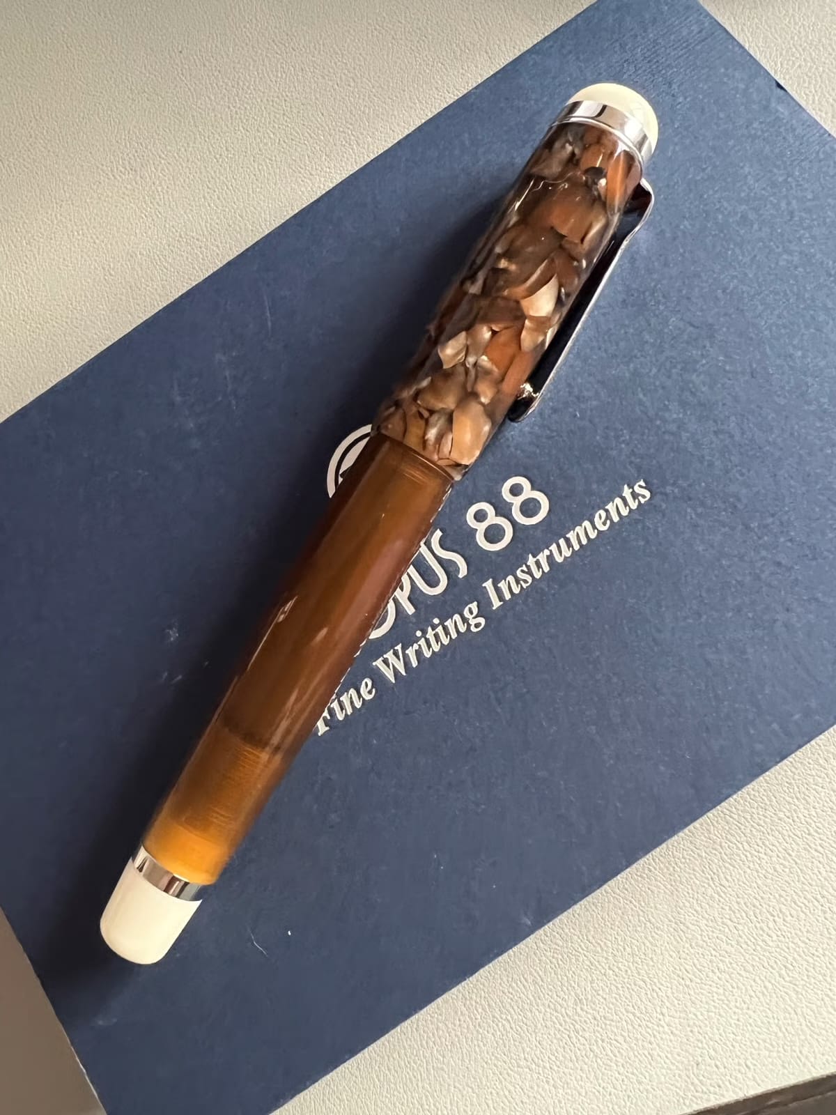 The Korean Opus 88 Omar Brown lying on the the blue box it arrived in.