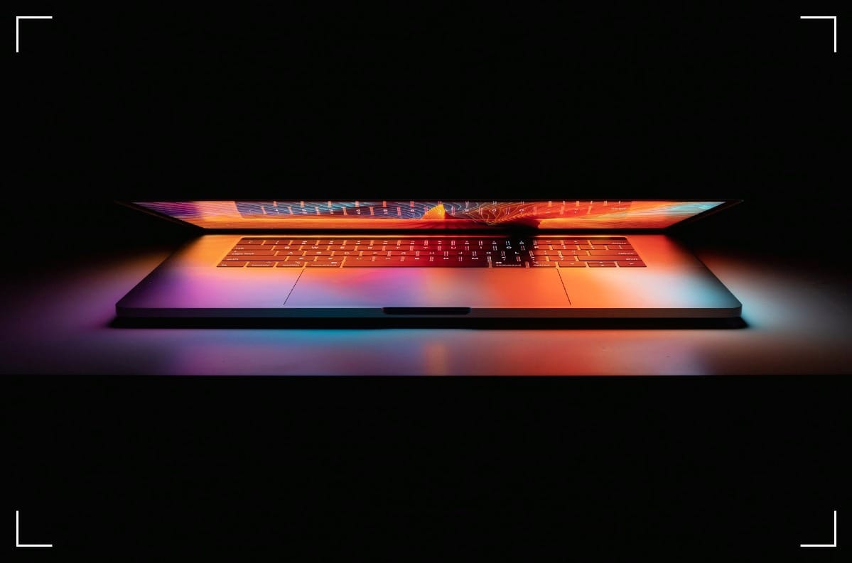 A gloomy but colorful picture of the front of a MacBook Pro.