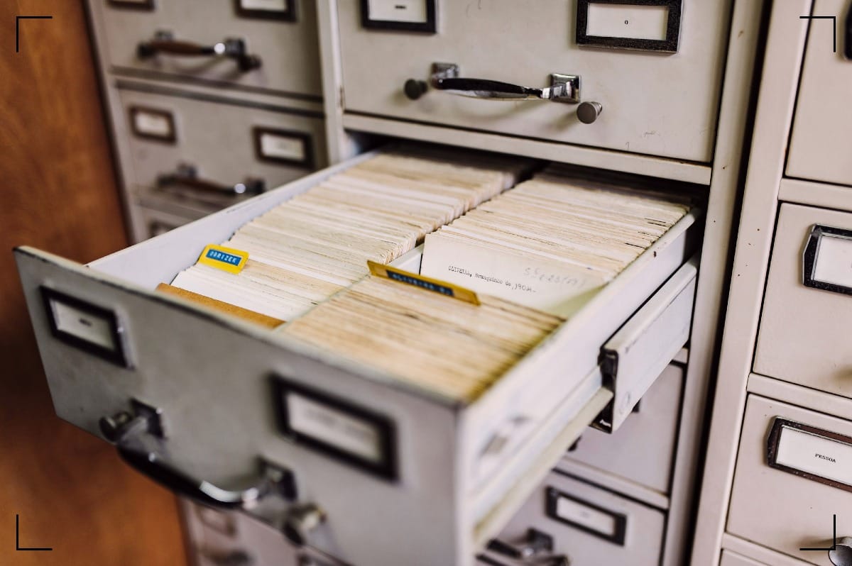 A drawer from a filing cabinet holding paper index cards.