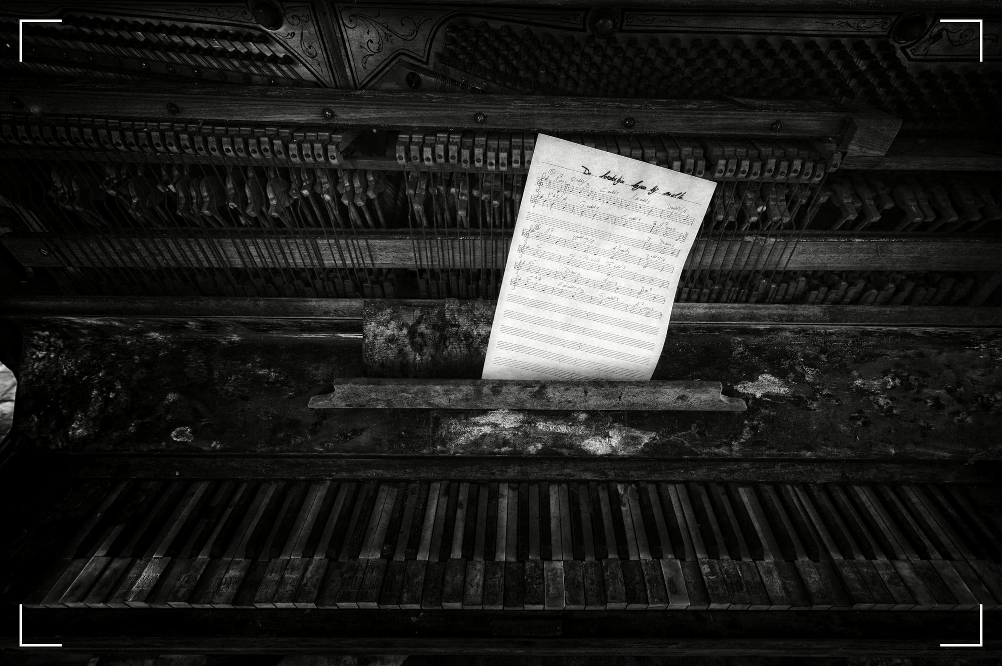 A piece of music paper stuck on to an old piano falling aparet. It's an illustration for Zoran Grbic' new story, The Last Note.