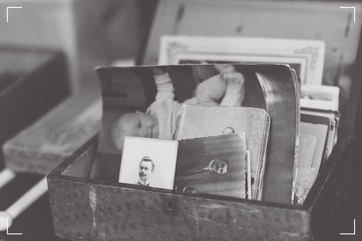An old, wooden box with very old, black & white prints.
