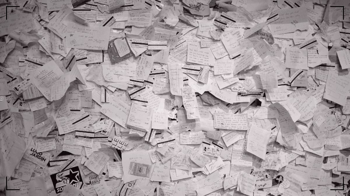 A huge amount of receipts lying ona flat surface.