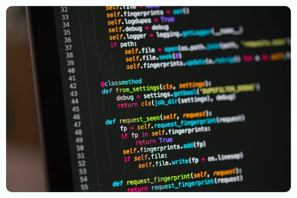 A laptop screen with lines of computer code on a black background.