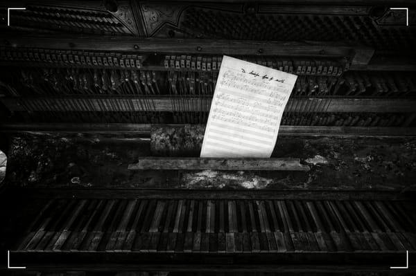 A piece of music paper stuck on to an old piano falling aparet. It's an illustration for Zoran Grbic' new story, The Last Note.