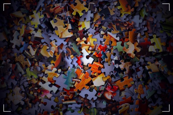 Loads of pieces of a puzzle outside of their box.