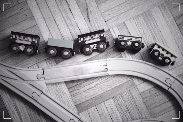 A wooden, toy train simmulating an accident.