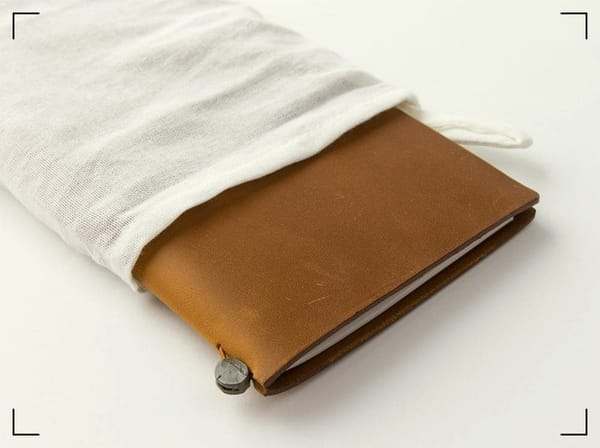 A leather Midori TN notebook cover.