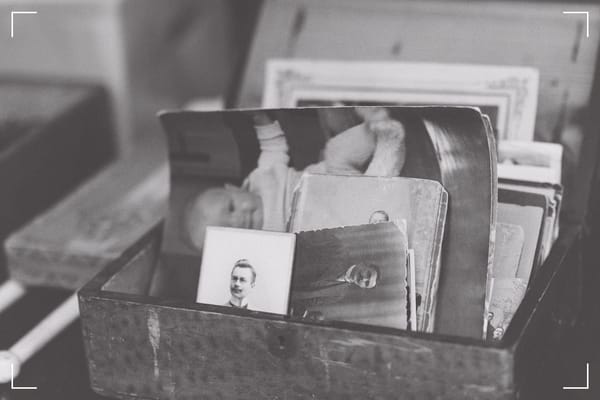 An old, wooden box with very old, black & white prints.